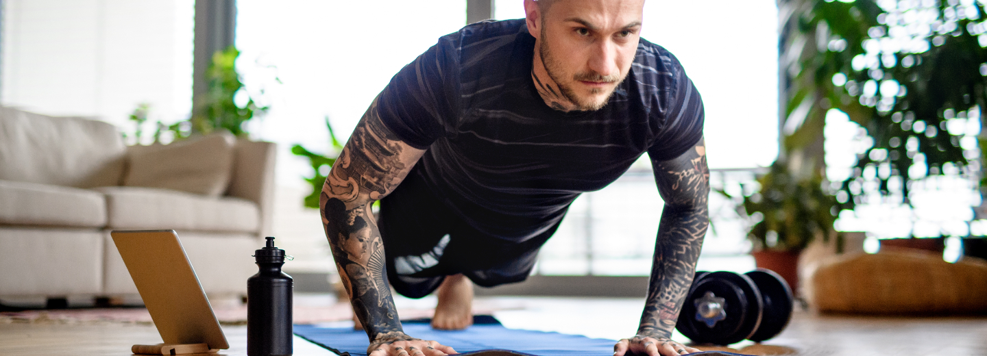 A man doing push ups on a mat