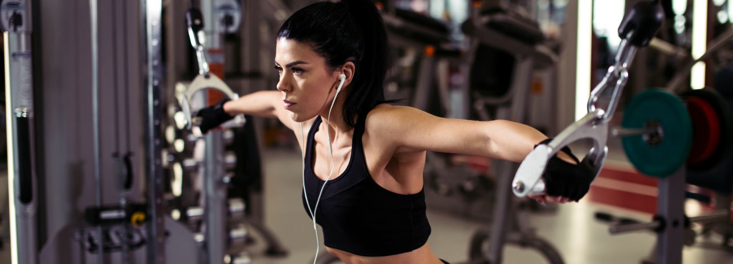 a woman training at a cable machine
