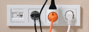 a close-up of an outlet with different power plugs