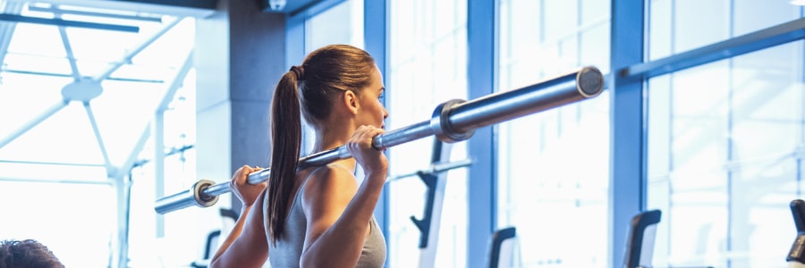 a woman lifting weights in a gym