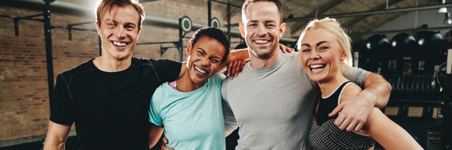 a group of people posing for a picture in the gym