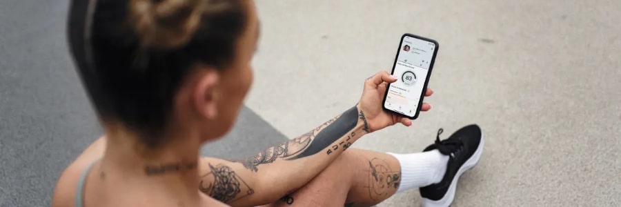 a person holding a phone with the Freeletics App